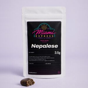 Nepalese THCP Hash front view, white resealable bag on a pale lilac studio background